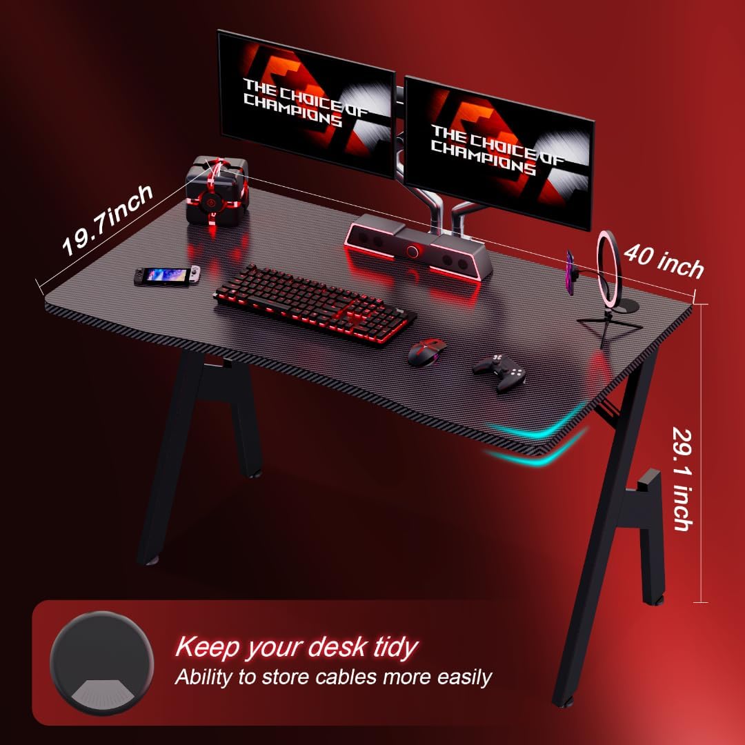 Compact gaming desk with dual monitors, red keyboard and accessories, showcasing desk dimensions and cable management port
